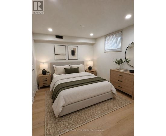 A bedroom with a large bed, two nightstands, and a mirror.