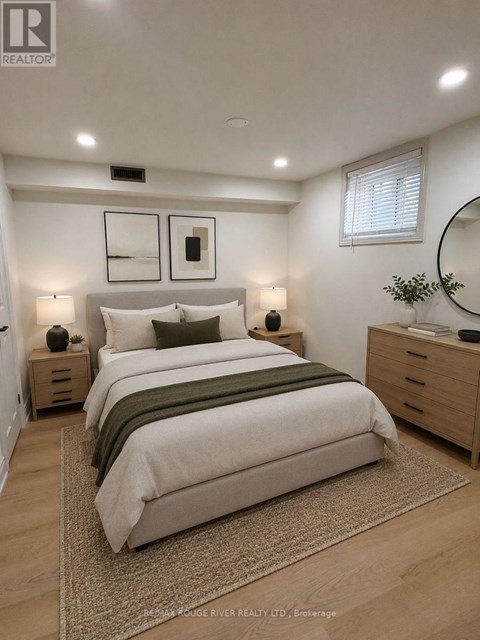 A bedroom with a large bed, two nightstands, and a mirror.