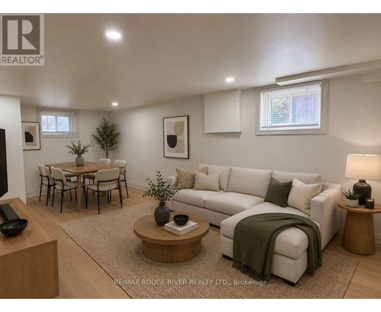 A living room with a couch, coffee table, and a dining table.