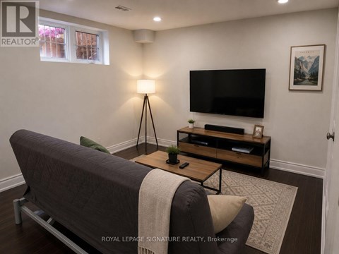 A living room with a grey sofa and a wooden coffee table.