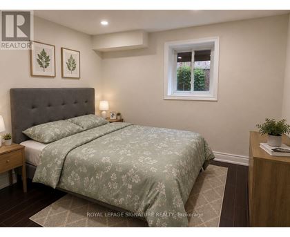 A bedroom with a bed, nightstand, and window.