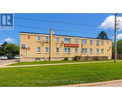 A building with the text RE/MAX EXCEL TITAN, Brokerage on it.