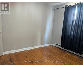 A room with a sliding door and wooden flooring.