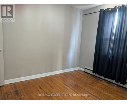 A room with a sliding door and wooden flooring.