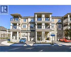 A blue car is parked in front of a two-story apartment building.