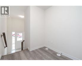 A room with a wooden floor and white walls.