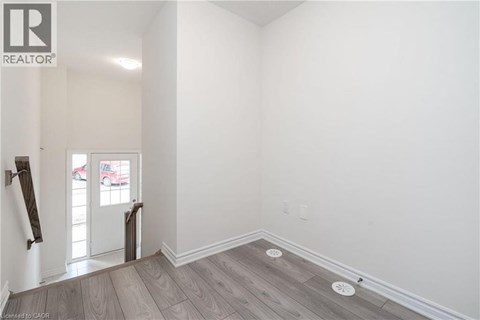 A room with a wooden floor and white walls.