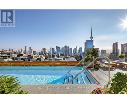 A pool with a slide and a view of the city skyline in the background.