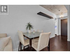 A dining room with a glass table and chairs.