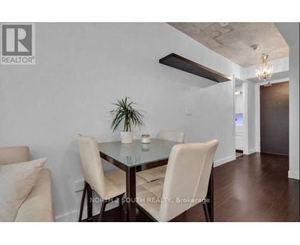 A dining room with a glass table and chairs.