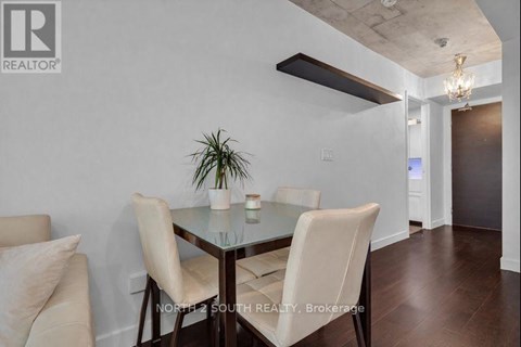 A dining room with a glass table and chairs.
