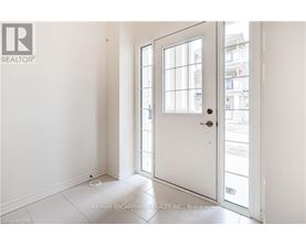 A white door with a glass window is open.