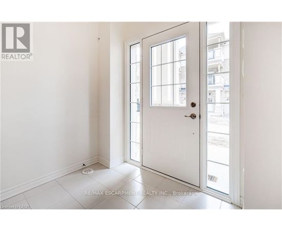 A white door with a glass window is open.