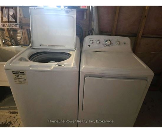 A white dryer and washer are sitting next to each other.