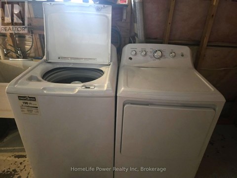 A white dryer and washer are sitting next to each other.