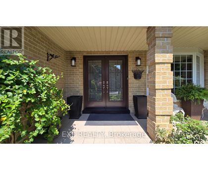 A house entrance with a glass door and a sign that says EXP REALTY Brokerage.