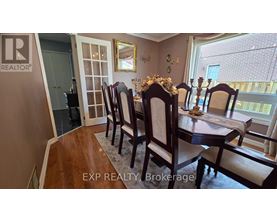 A dining room with a table set for four.