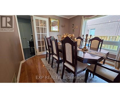 A dining room with a table set for four.