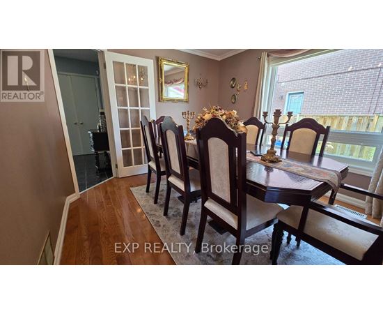 A dining room with a table set for four.