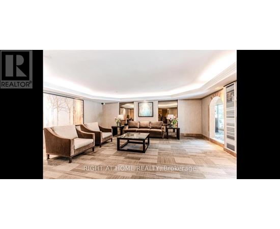 A spacious living room with a large couch and a coffee table.
