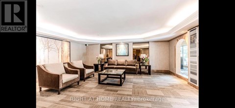 A spacious living room with a large couch and a coffee table.