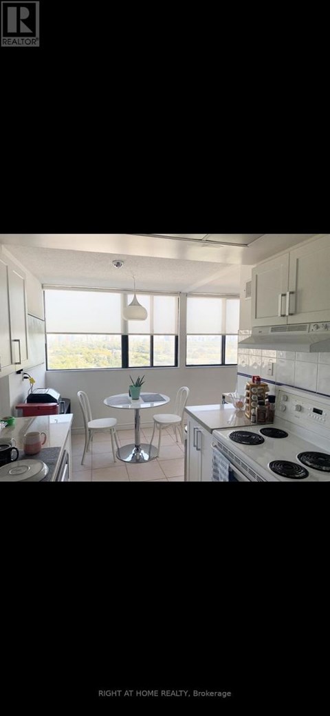 A modern kitchen with white cabinets and a large island.