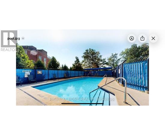 A pool surrounded by a blue fence.