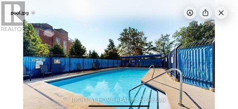 A pool surrounded by a blue fence.