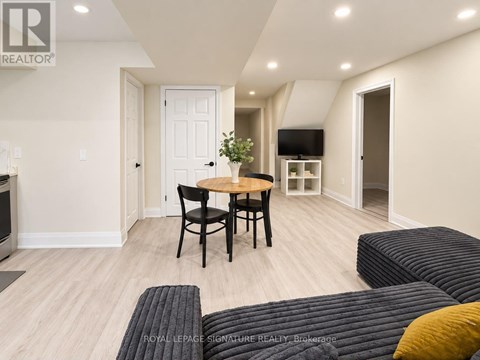 A living room with a table and chairs.