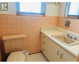 A bathroom with a toilet, sink, and bathtub.