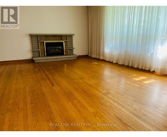 A room with a fireplace and wooden floors.