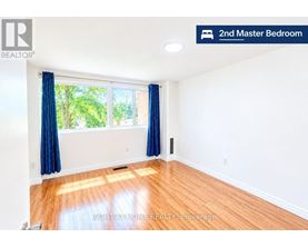 A bedroom with a window and blue curtains.