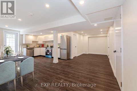 A well-lit kitchen with a dining table and chairs in a house.