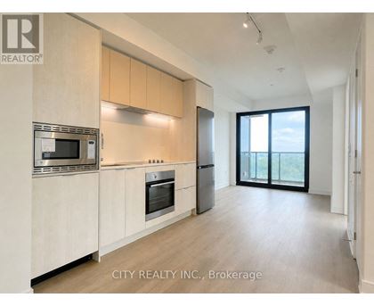 A modern kitchen with wooden cabinets and stainless steel appliances.