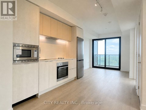 A modern kitchen with wooden cabinets and stainless steel appliances.