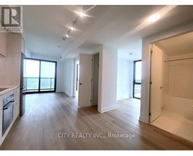 A spacious room with wooden flooring and white walls, part of a property for brokerage by City Realty INC.
