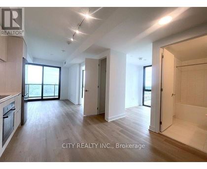 A spacious room with wooden flooring and white walls, part of a property for brokerage by City Realty INC.