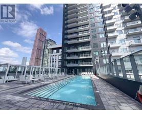 A pool on a balcony of a building with a sign that says "Dream Home Realty, N.C., Brokerage".