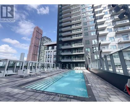 A pool on a balcony of a building with a sign that says "Dream Home Realty, N.C., Brokerage".