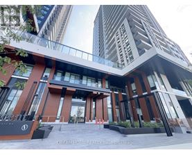 A modern building with a glass entrance and a sign that reads "Dream Home Realty Inc. Brokerage".