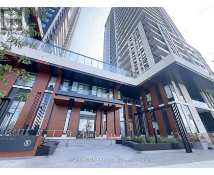 A modern building with a glass entrance and a sign that reads "Dream Home Realty Inc. Brokerage".