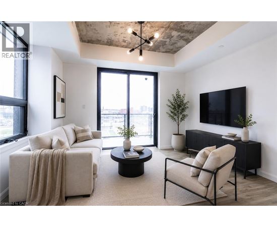A living room with a couch, chair, and television.