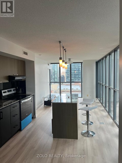 A modern kitchen with a bar stool and a counter.