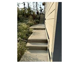 A set of concrete stairs leads up to a building.