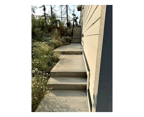 A set of concrete stairs leads up to a building.