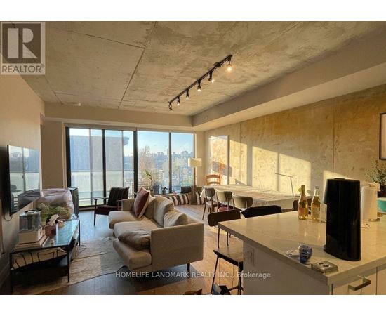 A living room with a couch, a chair, a table, and a television.