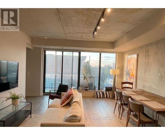 A living room with a couch, chairs, and a television.