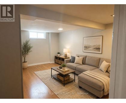 A living room with a couch, a coffee table, and a potted plant.