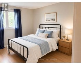 A bedroom with a bed, nightstand, and a window with blue curtains.