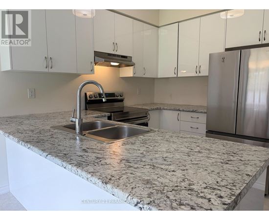 A kitchen with a granite countertop and stainless steel appliances.